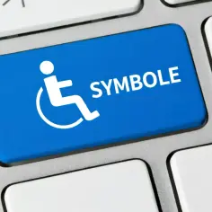 Niebieski klawisz z białym symbolem osoby na wózku inwalidzkim i napisem "SYMBOLE".